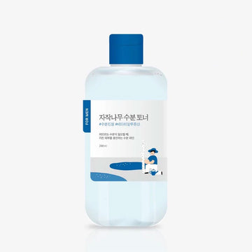 Bottle of toner with blue cap and label on a white background.