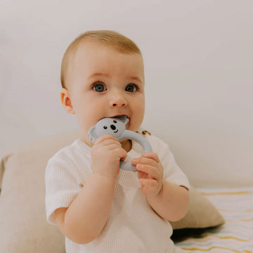 A dark grey teething ring with a koala head on top.