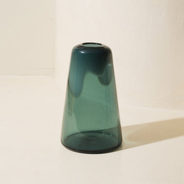 Green glass vase on a white background.