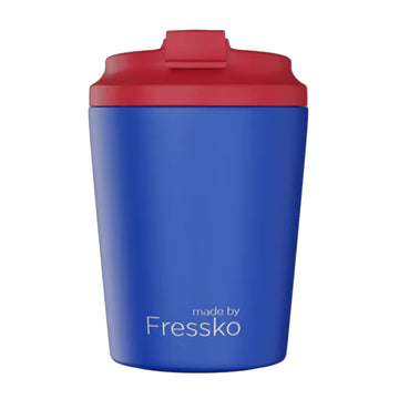 A reusable coffee mug in blue with a red lid.