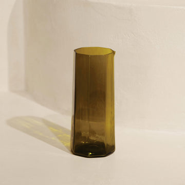Olive green glass vase on a white background.