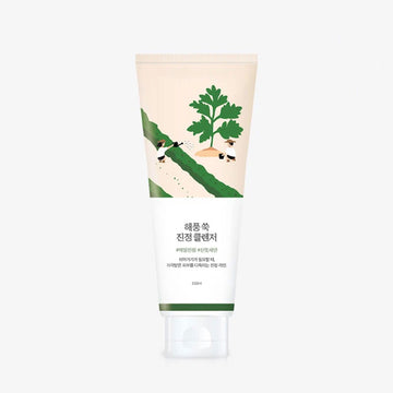 Tube of cream with green leaf design on a white background.