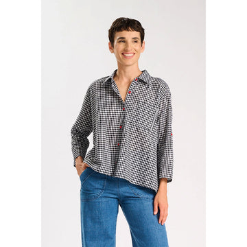 Black and white checkered shirt with red buttons on a white background.