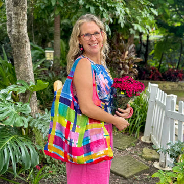 A reusable shopping bag printed with a colourful gingham style print.