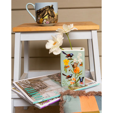 A ceramic rectangle vase illustrated with birds and flowers.