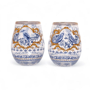 A set of two glass tumblers illustrated with birds and plants in a blue colour scheme with gold frames.