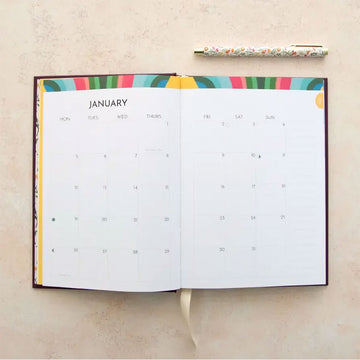 2026 purple planner with floral design on a beige background.