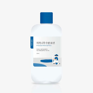 Bottle of skincare solution with blue cap and label on a white background.