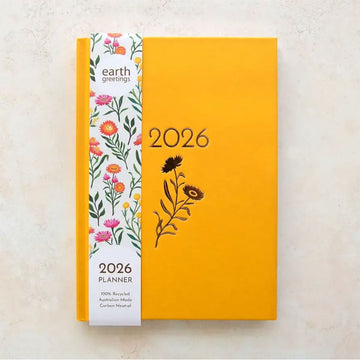 Yellow planner with floral design and '2026' text on a light background.