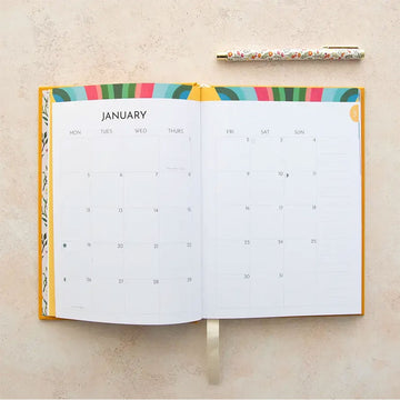 Yellow planner with floral design and '2026' text on a light background.
