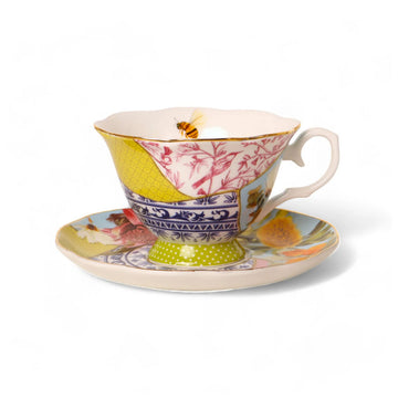 A ceramic tea cup and saucer printed with a kintsugi-style design with illustrations of flowers, birds and motifs.