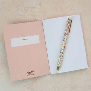 Pocket notebook with a design of black cockatoos and banksia on a beige background, featuring the brand 'earth greetings'.