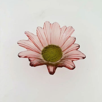 A glass pink bowl in the shape of a flower.