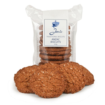 A packet of Anzac biscuits in clear packaging with a few biscuits in front.