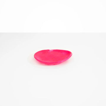 A resin side plate in a irregular shape in bright pink.