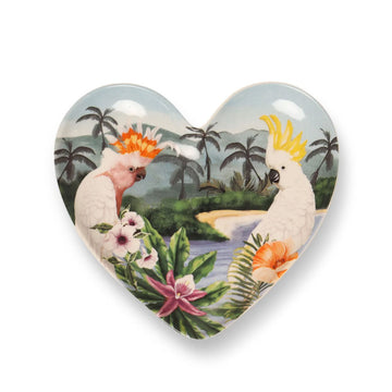 A heart shaped trinket tray illustrated with a Major Mitchell cockatoo and a white cockatoo surrounded by flowers and a beach in the background.