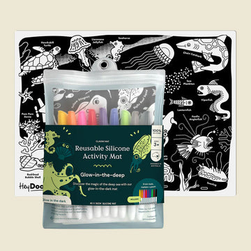Reusable silicone activity mat with glow-in-the-dark markers and underwater-themed design.