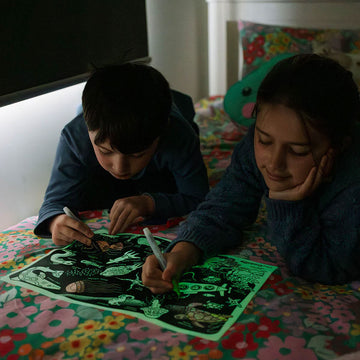 Reusable silicone activity mat with glow-in-the-dark markers and underwater-themed design.