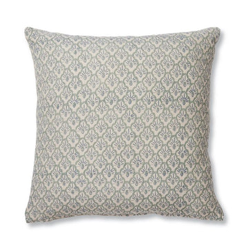 A square cushion printed with a repeating pattern of scalloped shapes in blue.