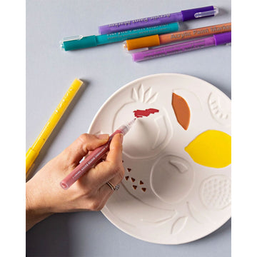 A box titled 'Colour Your Own Plate' with a picture of a plate illustrated with fruits and coloured pens on either side.