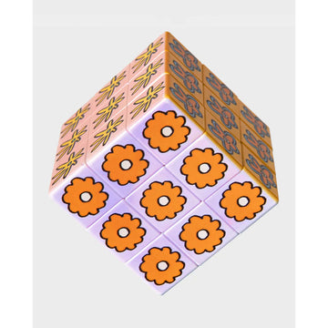 A rubik's style cube with different illustrated flowers on each square.