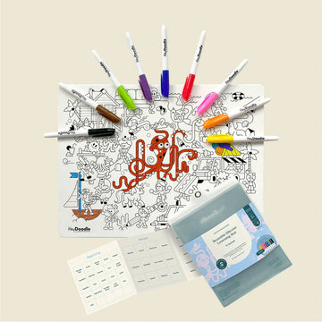 Reusable silicone learning mat with colorful markers on a dark green background.