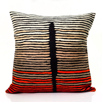 Decorative pillow with black, beige, and red striped pattern on a white background