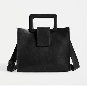 Front view of a black leather tote bag with a rectangle handle and a long cross body strap.