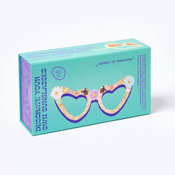 A blue box with the heading 'Decorate Your Own Sunglasses' and an illustration of heart shaped glassed with flowers and gems on the frames.
