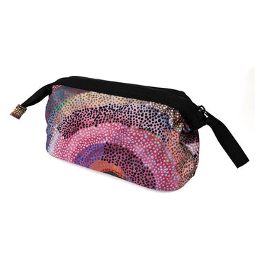 A cosmetic bag printed with artwork by Marianne Burton with a thick black zip along the top.