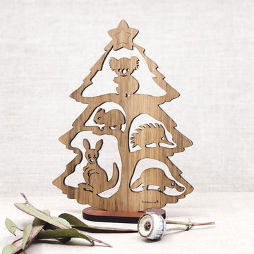 A wooden 2D Christmas tree with cut outs of Australian animals on the tree.