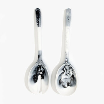 A pair of salad servers made from resin in white marble.