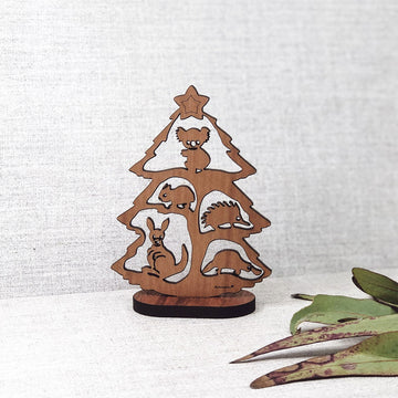 A wooden 2D Christmas tree with cut outs of Australian animals on the tree.
