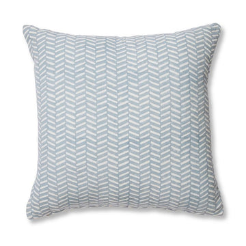 A square cushion with a blue herringbone pattern.