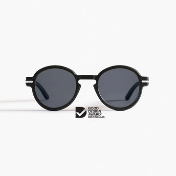 Round black sunglasses with dark lenses on a white background, featuring the Good Design Award logo.