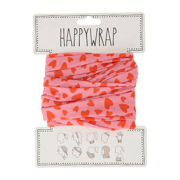 A piece of fabric printed with red hearts on a pink background on a white card titled 'HappyWrap' with a image showing ten different ways to wear the happywrap. 