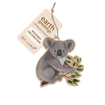 Wooden koala decoration with a tag labeled 'Earth Greetings' on a white background