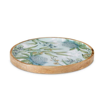 A round wooden platter printed with blue and yellow flowers with green leaves on the inside.
