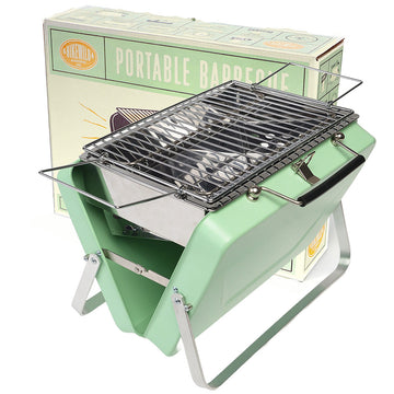 A foldable barbeque in green with its packaging box behind.