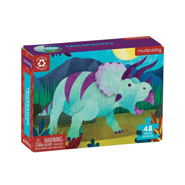 A puzzle box with an illustration of a green and purple triceratops on the front.