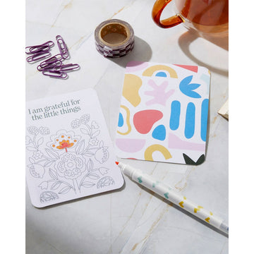 A square box titled 'Colour You Own Affirmation Cards' with a colourful abstract border.