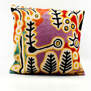 Colorful cushion with abstract pattern on a white background.