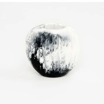 A small round resin vase with black and white marble swirls.