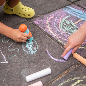 Box of Tiger Tribe chalk with colourful chalks inside on a white background.