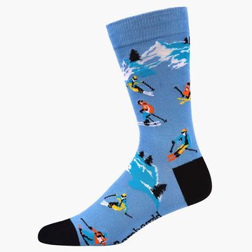 A blue sock with a black heel and toe and illustrated with people skiing.