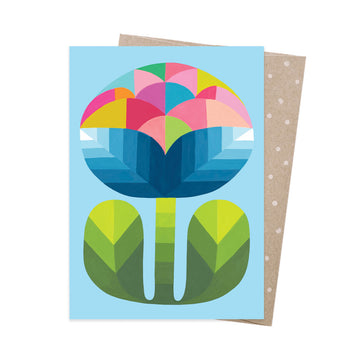Colorful geometric flower design on a blue card with a brown envelope.