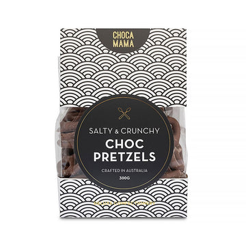 A card bag with a black and white pattern and a window showing chocolate covered pretzels inside.