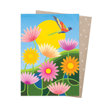 A greeting card with an illustration of a lorikeet flying over flowers.