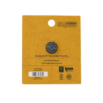 Shoe charm packaging with an eagle design on a yellow background.