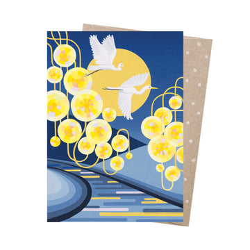 A greeting card with illustrations of white birds flying over yellow lights.